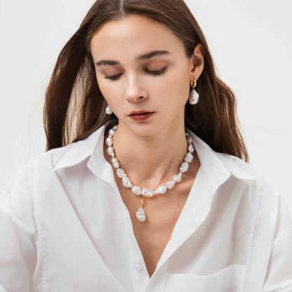 Woman wearing a pearl necklace with very high luster and earrings on a white background