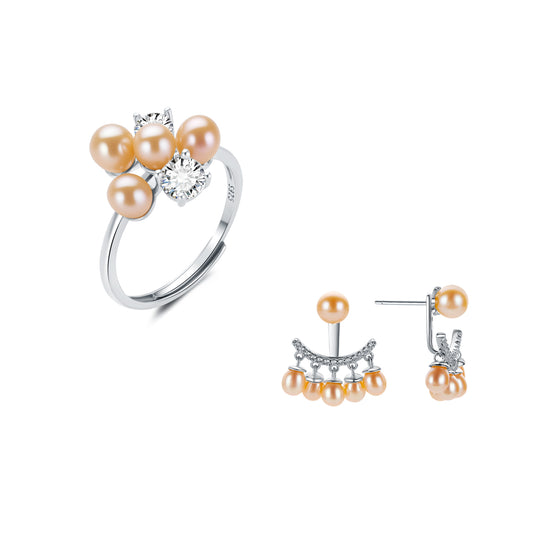 Pearl ring and earrings set on a white background
