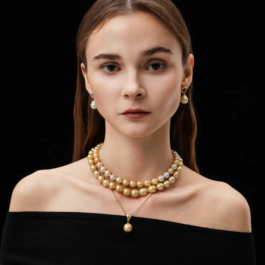 Woman wearing a 18k gold pearl necklace and earrings on a black background