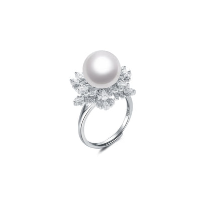 Pearl ring with gemstone accents on a white background