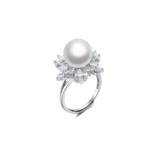 Pearl ring with gemstone accents on a white background