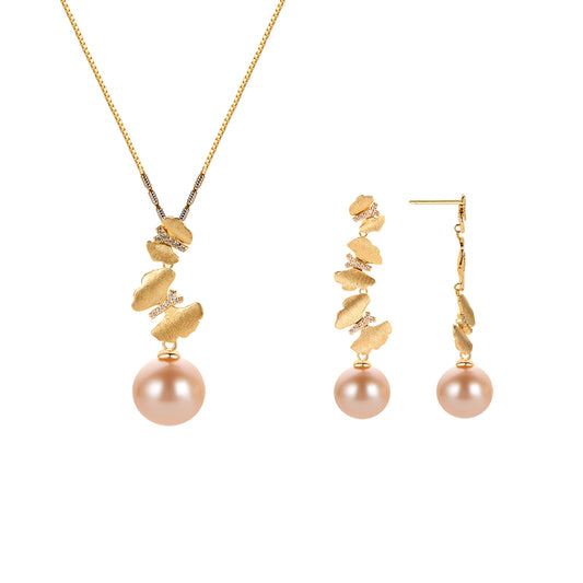 Gold butterflies necklace and earrings with pink pearls on a white background