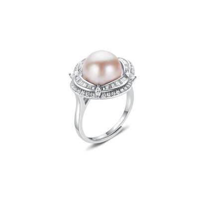 Pearl ring with gemstone accents on a white background
