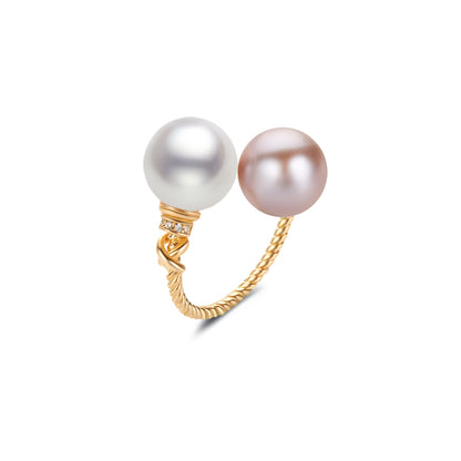 Gold ring with two pearls on a white background