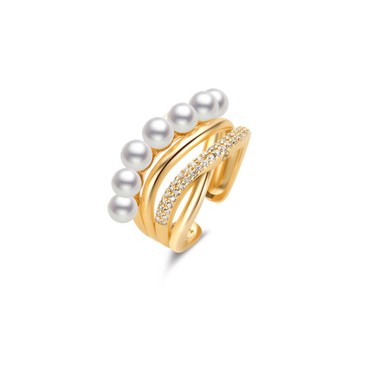 Gold ring with pearls and small gemstones on a white background