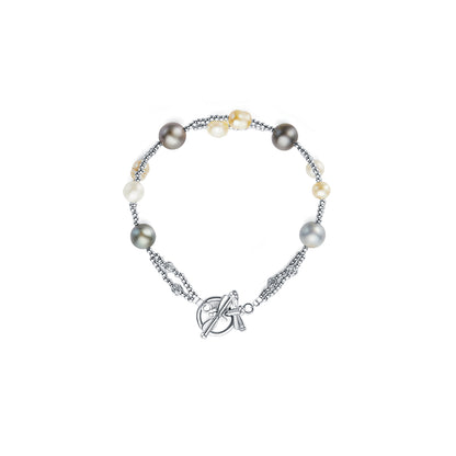 Pearl bracelet with silver chain and charm on a white background