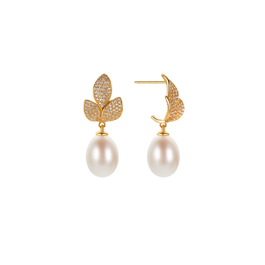 Pair of gold leaf-shaped earrings with pearl drops on a white background