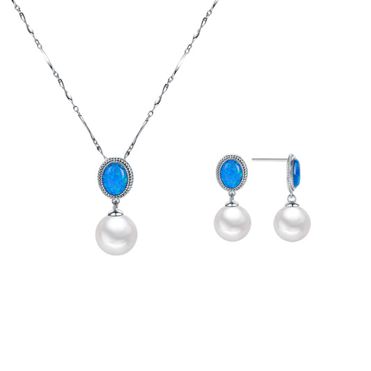 Jewelry set with pearls and blue stones on a white background