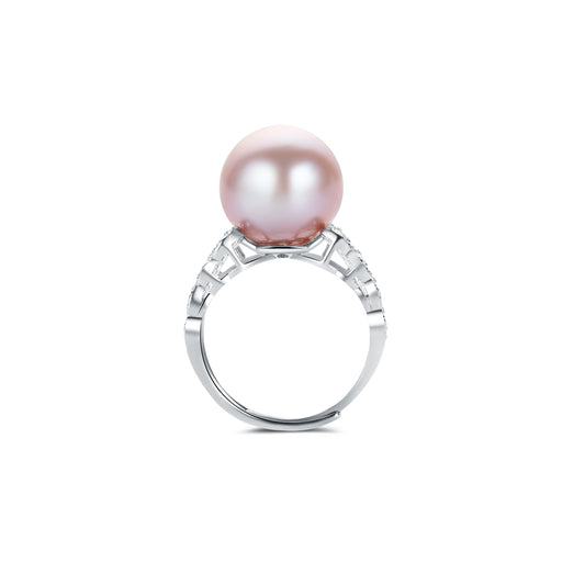 Pearl ring with gemstone accents on a white background