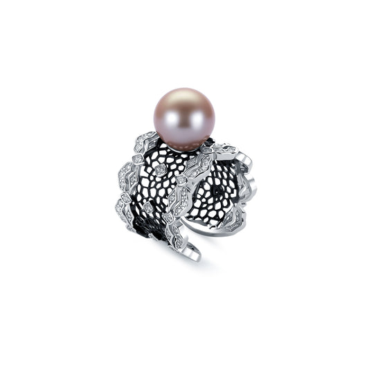 Pearl ring with intricate silver design on a white background