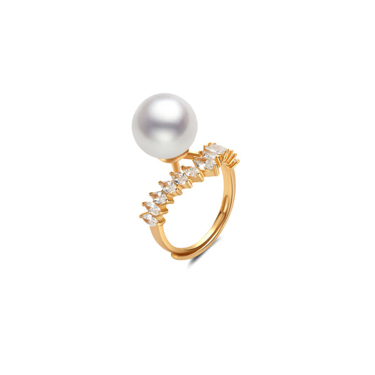 Gold ring with a pearl and small gemstone on a white background
