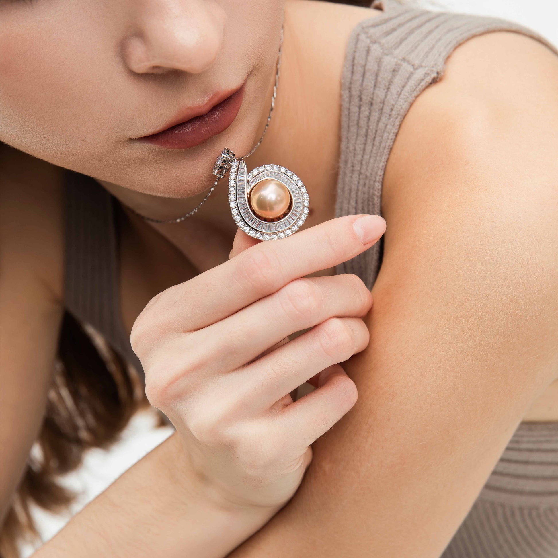 Close-up of a woman wearing a pearl necklace with a blurred background