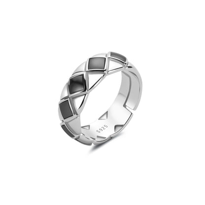 Silver ring with black geometric accents on a white background