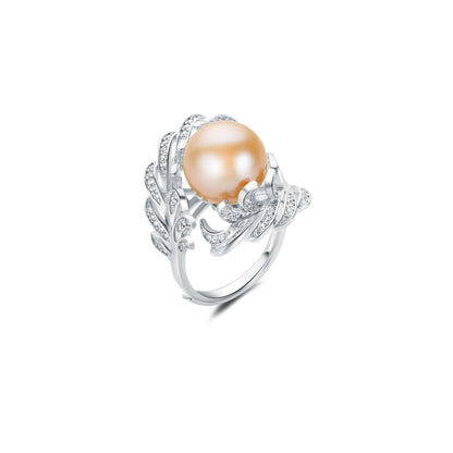 Silver ring with a large pearl and smaller stones on a white background