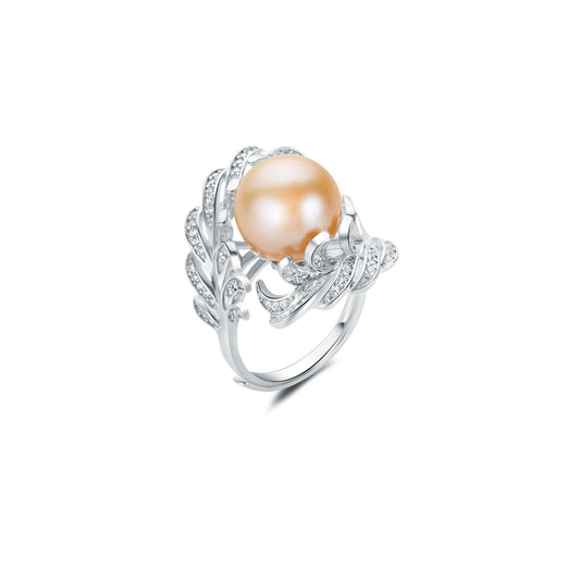 Silver ring with a large pearl and smaller stones on a white background